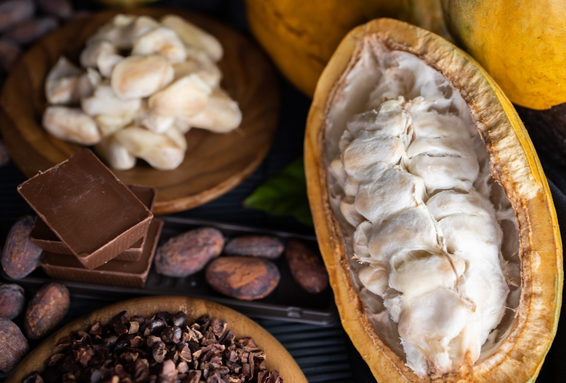 cocoa pods, beans and powder on wooden table, top view